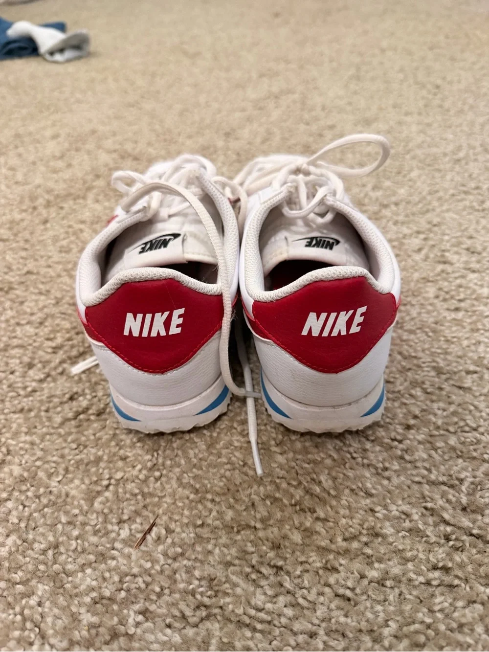 Nike White Sneakers with Red Swoosh and Blue Midsole Stripe